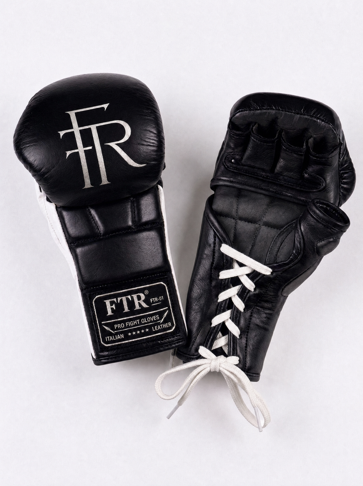 FTR-01 lace-up MMA gloves laid flat, angled view