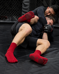 MMA fighter grappling wearing FiveStar grip socks